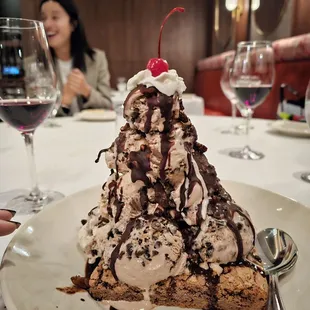 Peanut butter brownie with a whole tub of ice cream on it