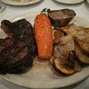 Bone-in prime rib, huge carrot, fried potatoes with gravy on the side