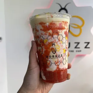 a hand holding a cup of bubble tea