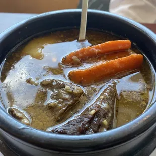 a bowl of stew with carrots