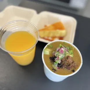 a bowl of soup and a cup of orange juice