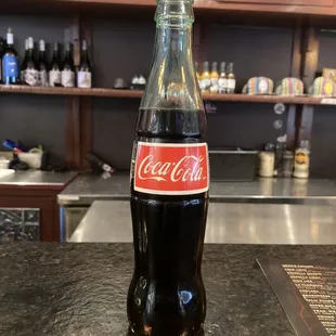 a bottle of coca cola on a counter