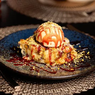 a dessert on a plate with a scoop of ice cream