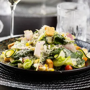 a plate of salad and a glass of wine