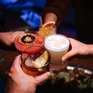 a group of people toasting with drinks