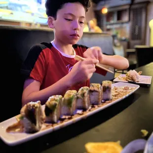 a boy eating sushi