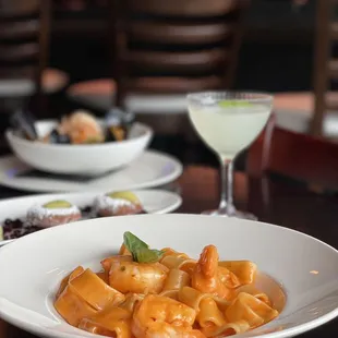 a plate of pasta and a glass of wine