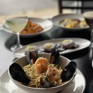 a bowl of pasta with shrimp and clams