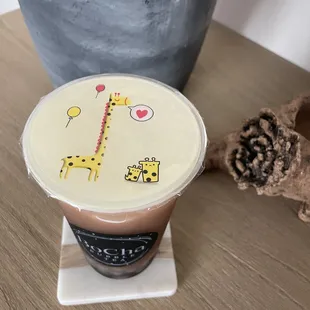 a cup of coffee with a giraffe on it