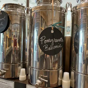 a row of stainless coffee urns