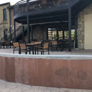 a patio with tables and chairs