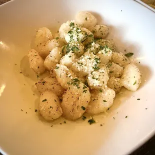 Gnocchi... tender potato dumplings poached and tossed with garlic, extra virgin olive oil, truffle pepper and parmesan.