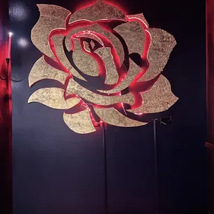 a red rose on a blue wall