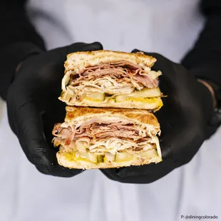 a person holding a sandwich