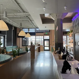 a large lobby area with a bar and chairs