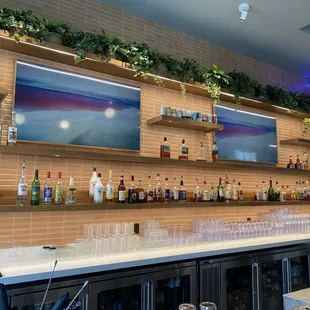 a bar with a lot of bottles on the shelves