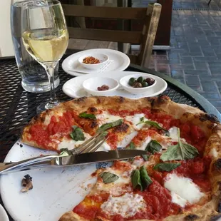 a plate of pizza and a glass of wine