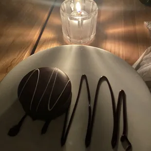 a chocolate covered donut on a plate