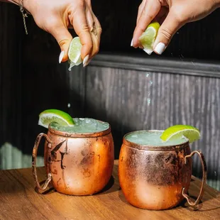 two copper moscow mules with lime wedges