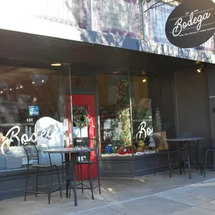 the outside of a restaurant with tables and chairs