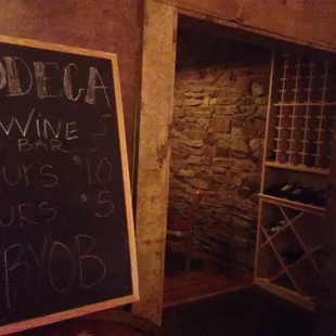 a chalkboard in a wine cellar