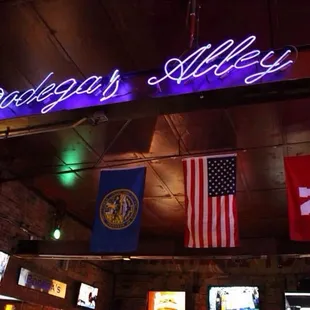 a neon sign above a bar