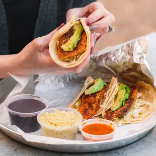 a woman eating a taco