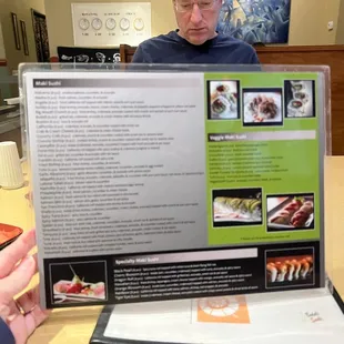 a man holding a menu