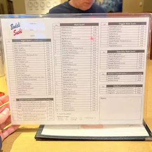 a person holding a menu