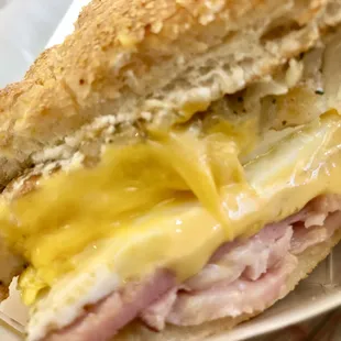 The Haystacker - a cross-section (Hoagie roll, American cheese, a potato pancake, fried eggs and ham). You can choose your bread and meat.
