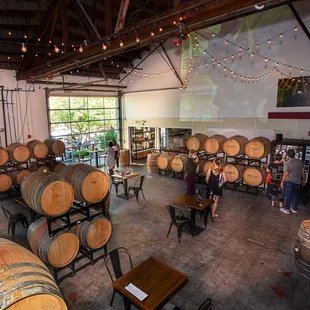 people standing in a wine cellar