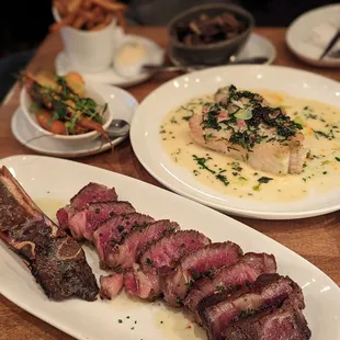 a plate of steak with a side of french fries