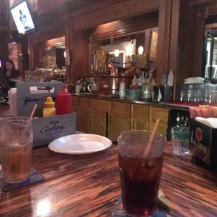 a bar with people sitting at the bar