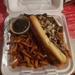 French dip sandwich with au jus and french fries.