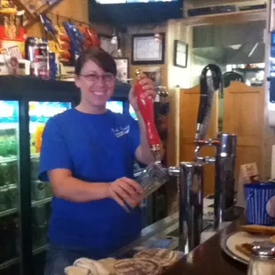 a woman behind a bar