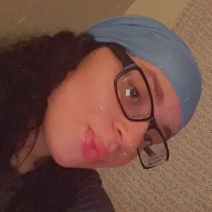 a woman with glasses and a bandana