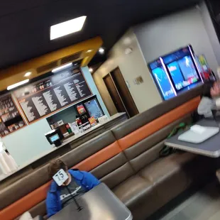 people sitting at tables in a restaurant