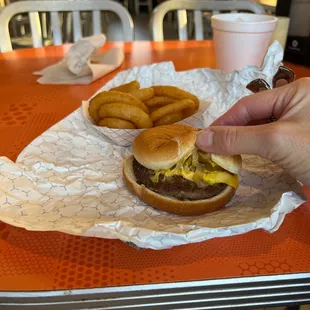 Single burger with onions that have been sautéed, cheese and mustard. Hope it's good because there's not much to it.