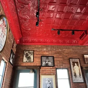 a brick wall with a red tin ceiling