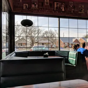 a woman sitting at a table in a restaurant