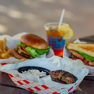 a burger and fries on a picnic table