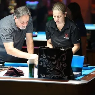 a man and a woman playing pool