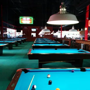 View from the back of the pool hall. There are more tables to the right of this photo.