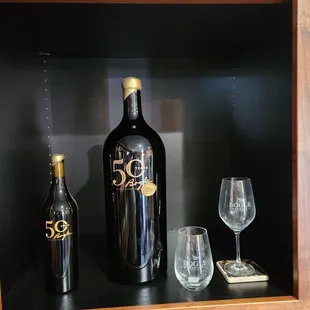 a bottle of booze and two wine glasses