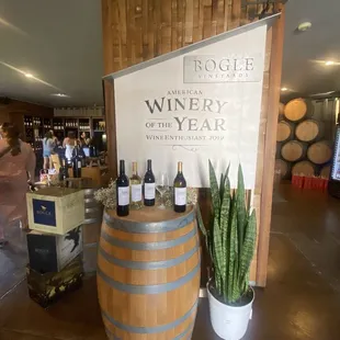 a display of wine bottles and barrels