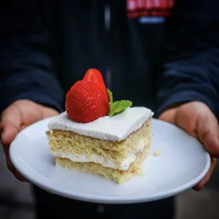 a piece of cake with a strawberry on top