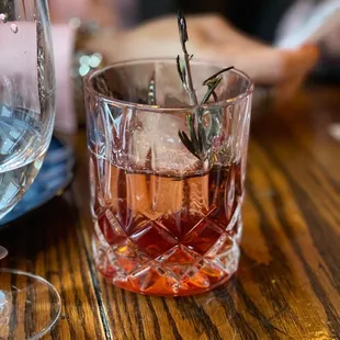 Smoked Rosemary Pomegranate Manhattan | Mt Gay Black Barrel rum, fresh pomegranate, Dolin Rouge, aromatic bitters, smoked rosemary