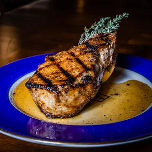 a piece of meat on a blue plate