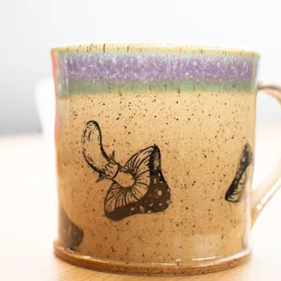 a coffee cup with a butterfly on it