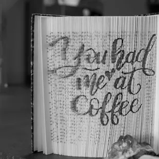 an open book with a cup of coffee